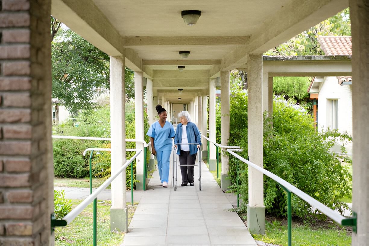Care in facilities — caregiver visiting patient in assisted living