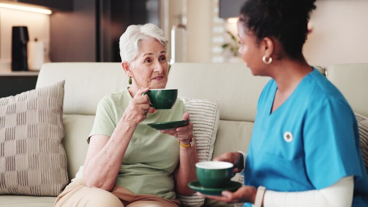 A family caregiver in a quiet moment with hands holding a warm cup